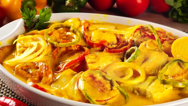 Slide shot Brazilian moqueca on the table with smoke. Top View