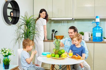 The family has Breakfast in the kitchen