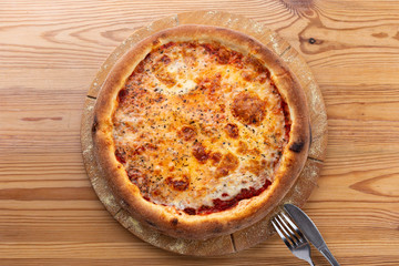 tomato-based cheese pizza. hearty italian pizza on a wooden board.