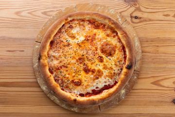tomato-based cheese pizza. hearty italian pizza on a wooden board.