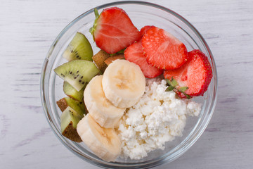 A bowl of milk and fresh fruit salad. Healthy food with vitamins.