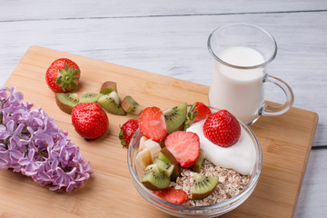 A bowl of milk and fresh fruit salad. Healthy food with vitamins.