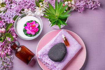 Obraz na płótnie Canvas Lilac composition for spas and Wellness centers. Towel frames and flowers.