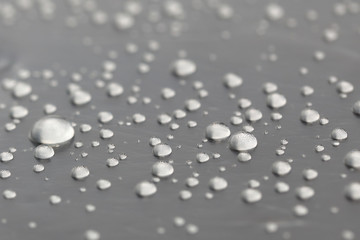 Background design made of water drops on a gray background	