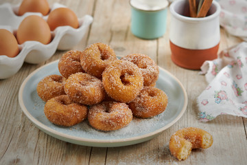 Closeup of a pile of homemade Doughnuts of easter, rosquillas, traditional anise donuts from Spain, typically eaten in Easter, on a rustic wooden table.
