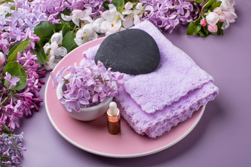 Lilac composition for spas and Wellness centers. Towel frames and flowers.