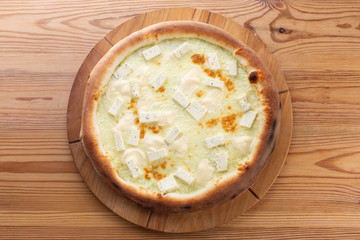 hearty italian pizza on a wooden board. hard cheese pizza