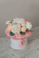 Artificial flowers. Decorative flowers as a gift. Flowers in a gift box. 