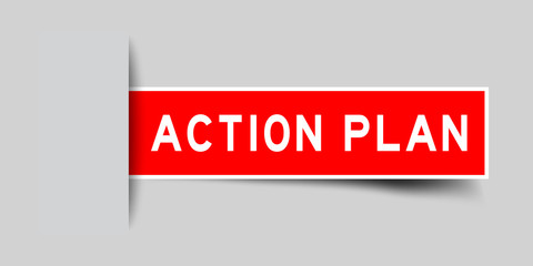 Inserted red color sticker label with word action plan on gray background