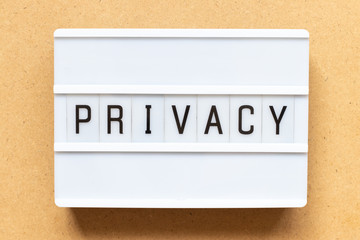 Lightbox with word privacy on wood background