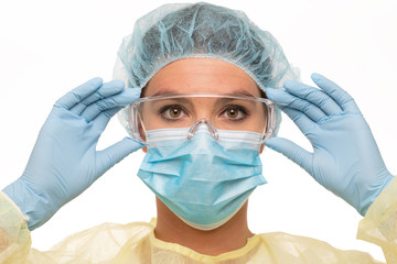 Close up of a female nurse as part of a medical team wearing personal protective equiment during covid-10 period