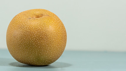 Asian pear fruit (Pyrus pyrifolia) on blue background