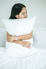  A woman sitting in a white pillow