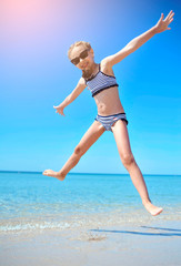 Cute little girl has fun on the beach. 