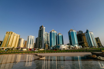 Fototapeta na wymiar Panoramic view of tall and beautiful skyscrapers with blue glazing | UNITED ARAB EMIRATES, SHARJAH - 17 OCTOBER 2017.