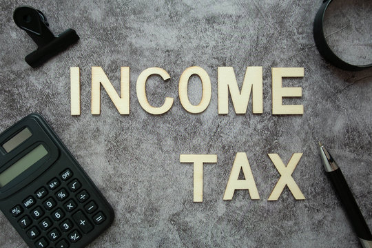 Wood text "Incone Tax" on clear background for Business concept.