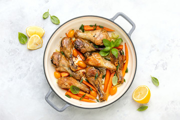 Chicken drumsticks slow cooked in a cast iron pan