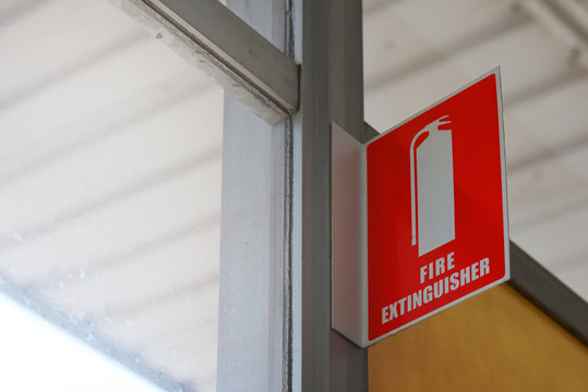 fire extinguisher sign near the window