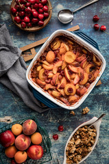 A top down view of a freshly baked stone fruit cobbler ready to be dished out.