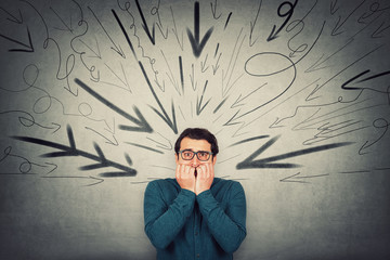 Stressful businessman, looks scared, biting his finger nails, nervous gesture, being under pressure...