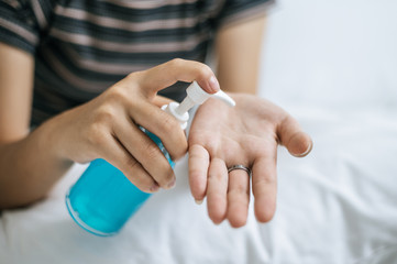 Young women wash hands with handwashing gel.