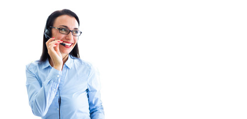 Beautiful consultant of call center in headphones.  Portrait of smiling female customer using headset at call center office