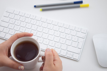 Take a break and drink tea. Topview office desktop. Keyboard, mouse, office materials. 