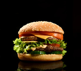 Burger cheeseburger bbq sandwich with beef cheese and fresh vegetables hot with steam smoke on black