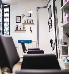 Empty hair salon interior with chairs and mirrors.