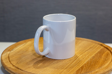 white ceramic mug for sublimation on a wooden stand