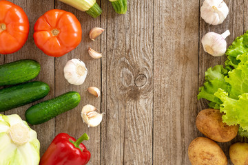 Assorted vegetables on a wooden background. Template for text, top view.