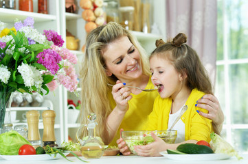 Portrait of smiling mother and daughter cooking together