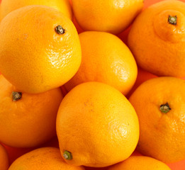 Background of juicy fruit oranges. The texture of the Mandarin. fruits. Backgrounds