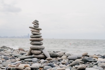 stones on the beach in the shape of a pyramid. balance and meditation, space for text