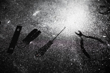 Traces of tools on a black table dusted with white dust