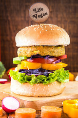 vegan snack, meatless hamburger, with small plate written in English Vegan life, gluten free, made with different vegetables and proteins. Vegetarian, healthy lifestyle.