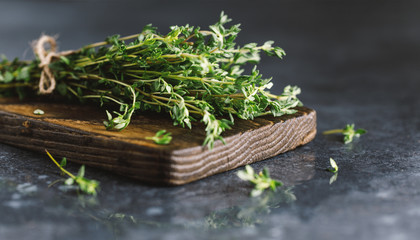 Close up view of thyme bunch. Herb thyme on table - obrazy, fototapety, plakaty