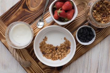 Delicious homemade granola, a healthy breakfast on a wooden tray top view