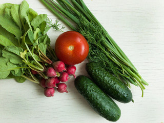Fresh and juicy vegetables are placed in a white wooden background, top view