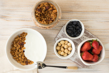 Granola with yogurt, nuts, strawberries and theiryum, delicious healthy breakfast