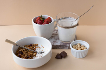 Plate with muesli, nuts and strawberries, healthy breakfast