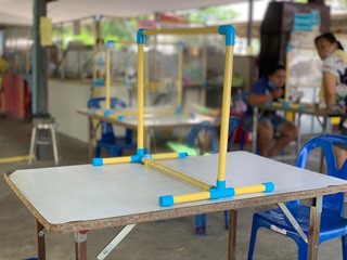 Social distancing rules in practice, alternate seating in local public food courts are separated in...