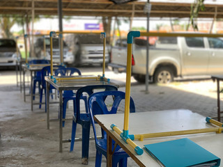 Social distancing rules in practice, alternate seating in local public food courts are separated in restaurant with table shield plastic partition to protect infection from coronavirus covid-