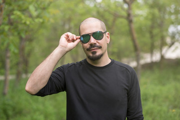Cool bald man with sunglasses portrait