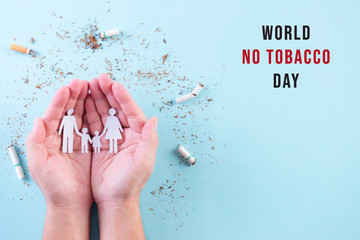 Hand protect family from cigarette on light blue background. Stop smoking for your family. World No Tobacco Day concept. Copy space for advertisers. - obrazy, fototapety, plakaty