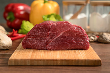 Raw beef with wooden table background