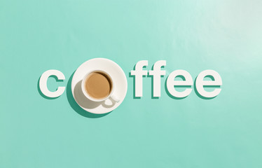 White coffee lettering on abstract pastel cyan background with cup as letter o
