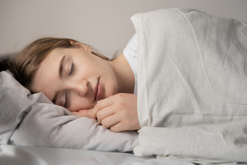 beautiful girl sleeps in the bedroom, good sleep excellent health.