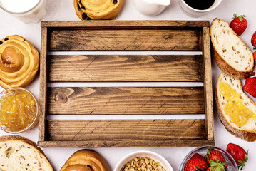 Tasty Breakfast Freshly Baked Buns with Raisins and Cinnamon Fresh Homemade Bread Cup of Black Coffee Cream Ripe Strawberry and Orange Jam in Glass Bowl Top View Copy Space Frame Muesli