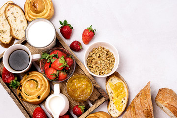 Tasty Breakfast Freshly Baked Buns with Raisins and Cinnamon Fresh Homemade Bread Cup of Black Coffee Cream Ripe Strawberry and Orange Jam in Glass Bowl Top View Copy Space Muesli